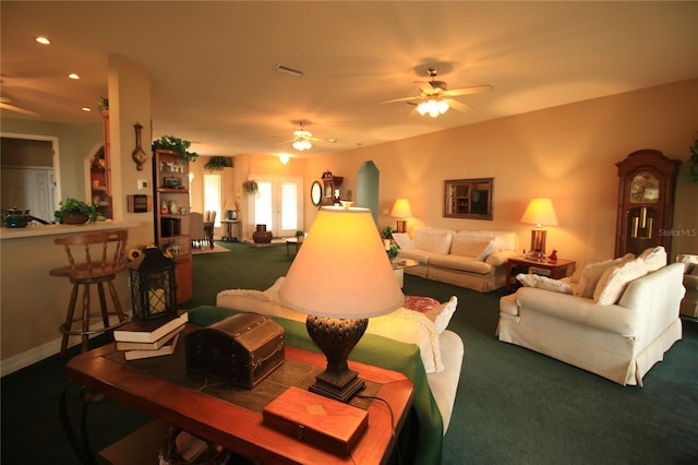 living room with ceiling fan and carpet