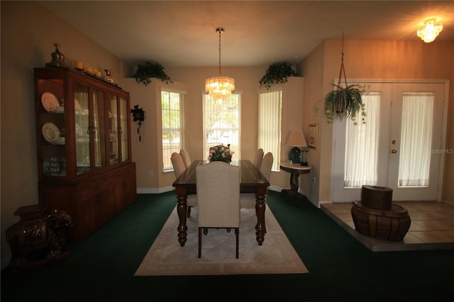 dining room with french doors and a chandelier