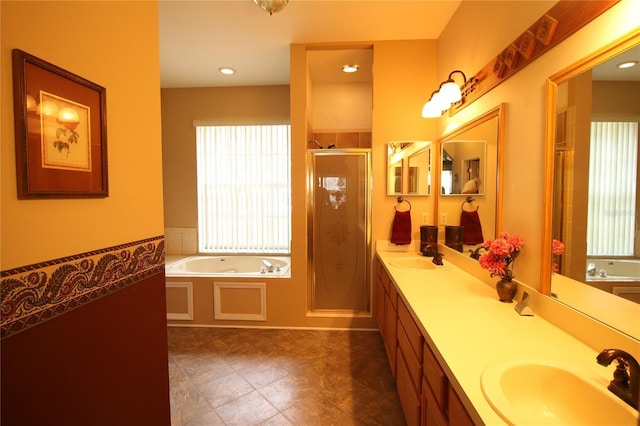 bathroom featuring plus walk in shower, tile patterned floors, and vanity