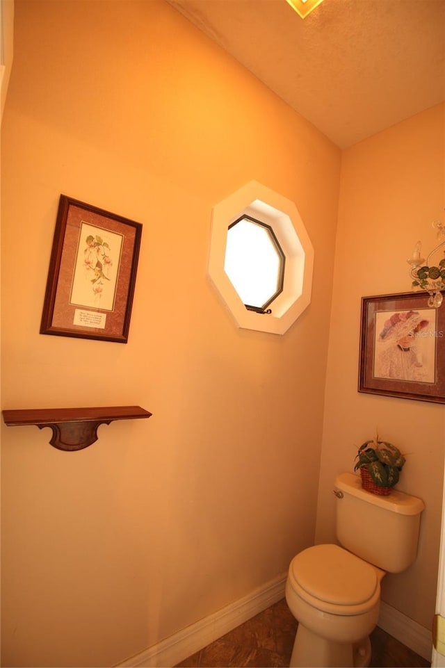 bathroom with toilet and tile patterned floors