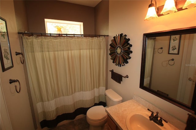 bathroom with toilet, vanity, and a shower with curtain