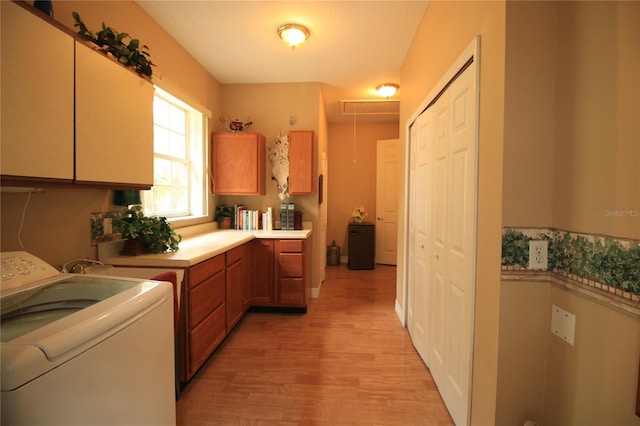 kitchen featuring washer / dryer and light hardwood / wood-style flooring