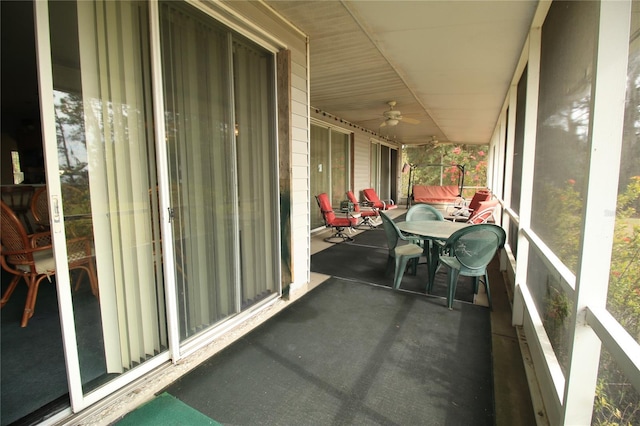 sunroom / solarium featuring ceiling fan