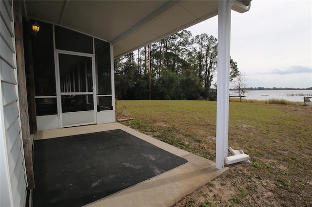 view of yard with a patio area and a water view