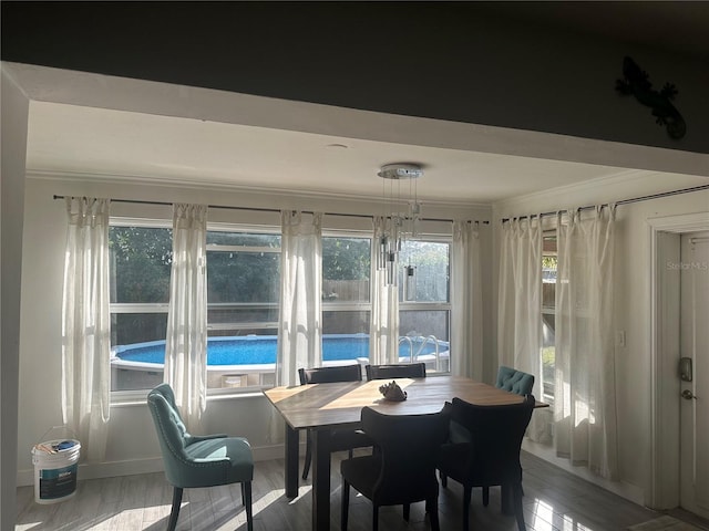 sunroom / solarium featuring a notable chandelier