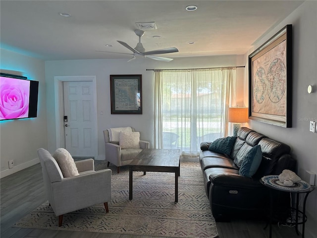 living room featuring ceiling fan and hardwood / wood-style flooring