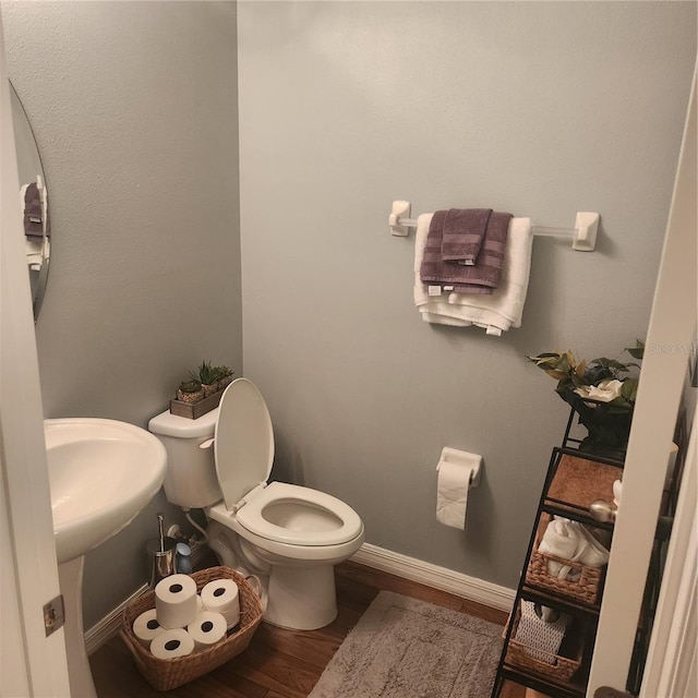 bathroom featuring toilet and hardwood / wood-style floors