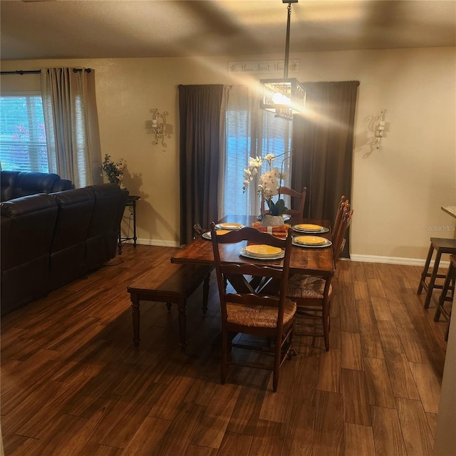 dining room with a chandelier and dark wood-type flooring