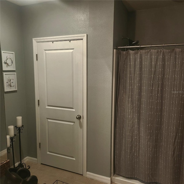 bathroom with tile patterned floors and a shower with shower curtain