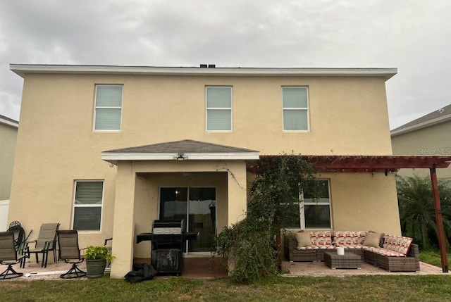 rear view of house featuring a yard, an outdoor living space, and a patio