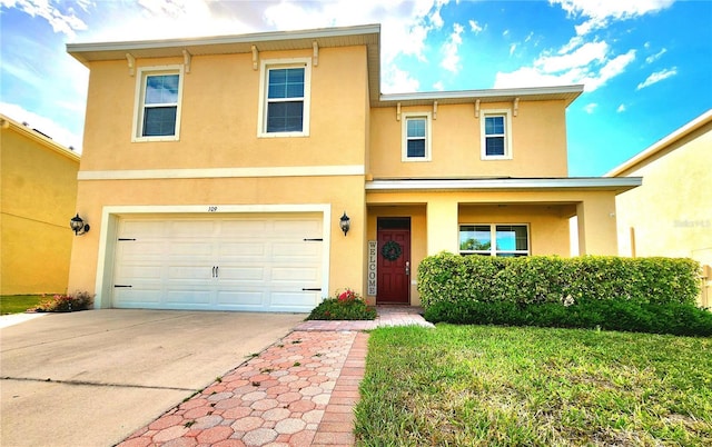 traditional-style home with a front yard, concrete driveway, a garage, and stucco siding