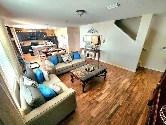 living area with light wood-style floors and baseboards