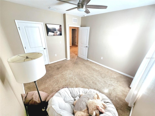 carpeted bedroom featuring a ceiling fan, visible vents, and baseboards