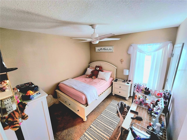 carpeted bedroom featuring a ceiling fan and a textured ceiling