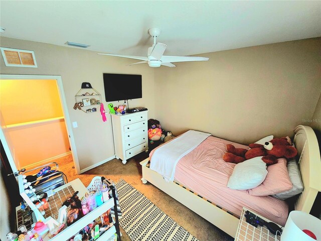 bedroom featuring baseboards, visible vents, ceiling fan, and light colored carpet