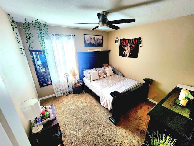 carpeted bedroom with a ceiling fan and baseboards