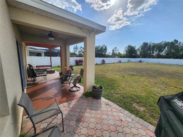 view of patio with ceiling fan, a fenced backyard, and a water view