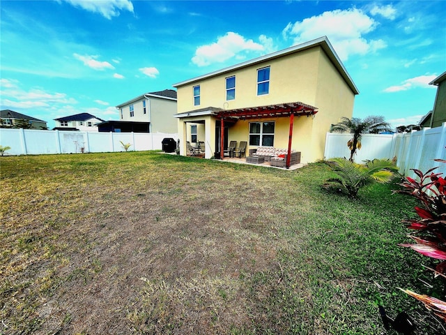 rear view of property with a patio, a fenced backyard, stucco siding, and a yard