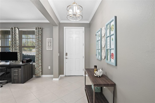 foyer entrance with light tile patterned floors, ornamental molding, and an inviting chandelier