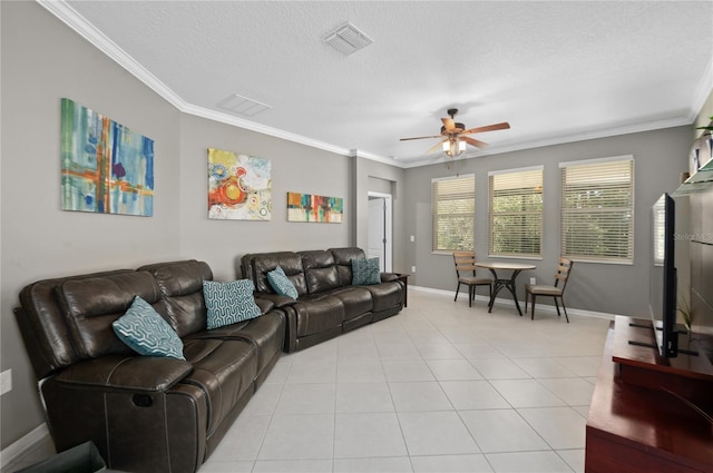 tiled living room with a textured ceiling, ceiling fan, and ornamental molding