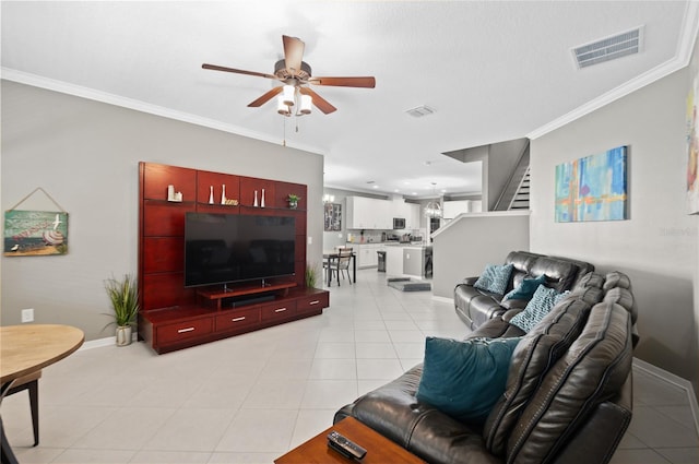 tiled living room with ceiling fan and ornamental molding