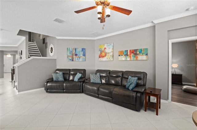 living room with ceiling fan, light tile patterned flooring, and ornamental molding