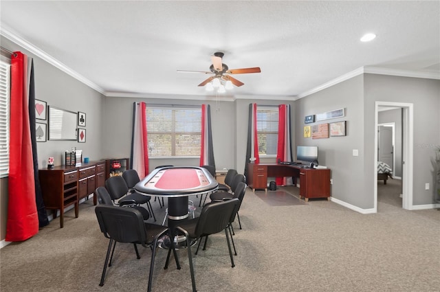 playroom with carpet floors, ornamental molding, ceiling fan, a desk, and baseboards