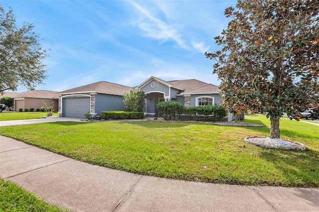 single story home featuring a garage and a front yard