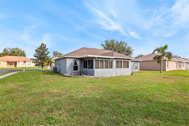 back of house with a lawn