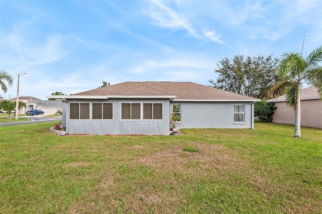 rear view of house featuring a yard