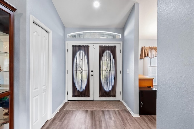 entrance foyer featuring hardwood / wood-style flooring and french doors