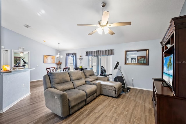 living room featuring vaulted ceiling, wood-type flooring, and ceiling fan