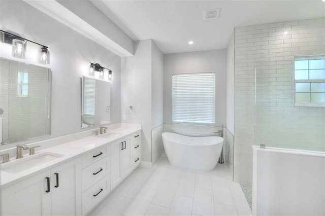 bathroom featuring tile patterned floors, separate shower and tub, and vanity