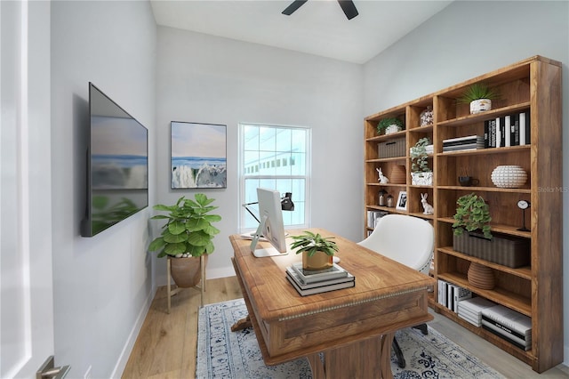 home office featuring light hardwood / wood-style flooring and ceiling fan