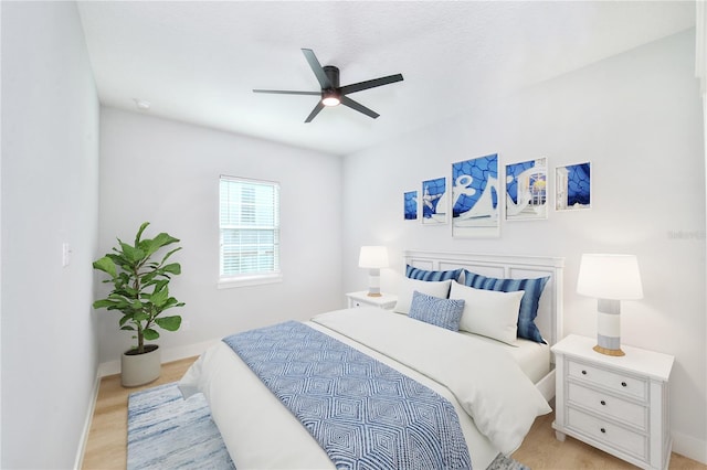 bedroom with ceiling fan and light hardwood / wood-style flooring