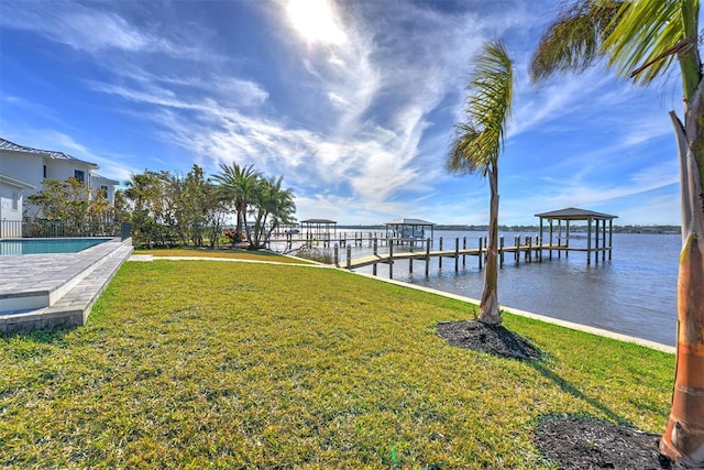 view of dock featuring a yard and a water view