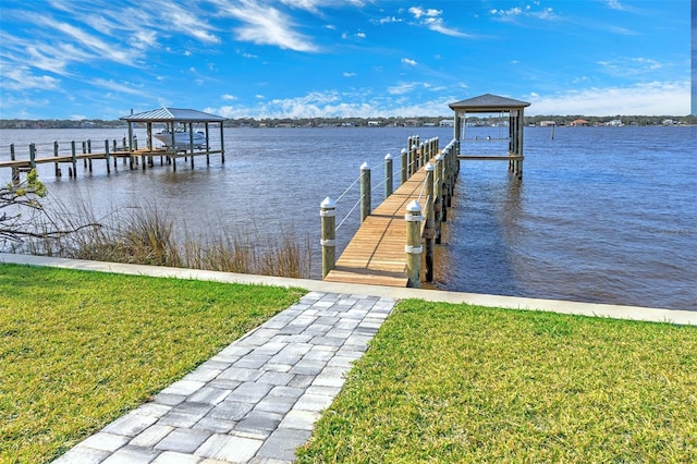 view of dock with a water view and a yard