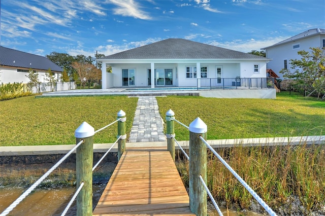 back of property featuring a patio area and a yard