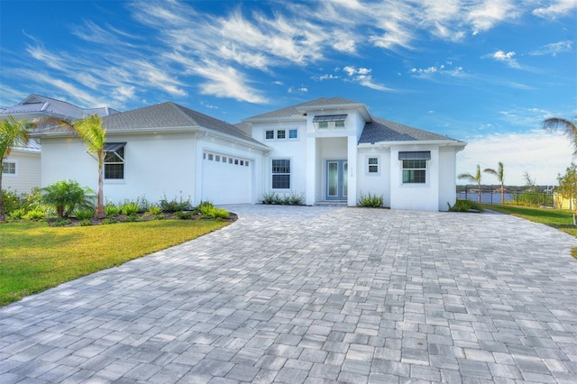 view of front of house with a garage and a front lawn