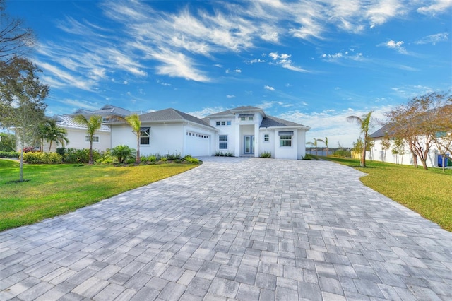 view of front of house with a garage and a front lawn