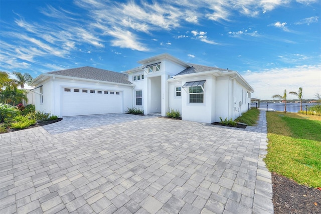 view of front of home with a front yard and a garage