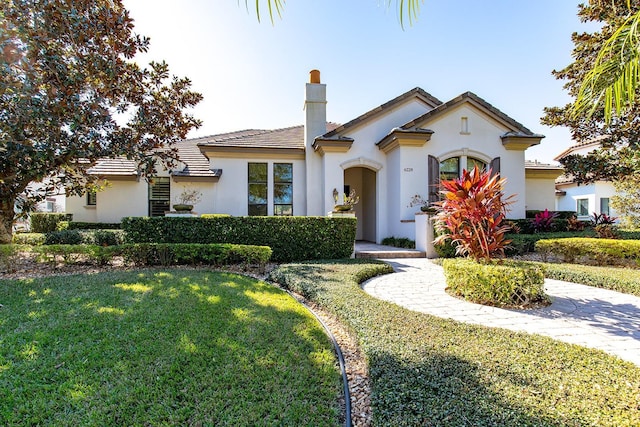 mediterranean / spanish-style house with a front yard