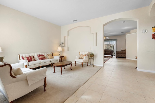 tiled living room with ceiling fan