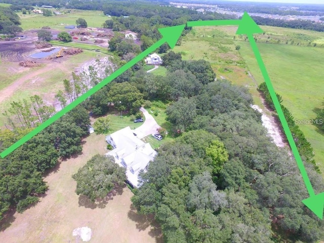 birds eye view of property featuring a rural view