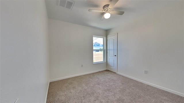 carpeted spare room featuring ceiling fan