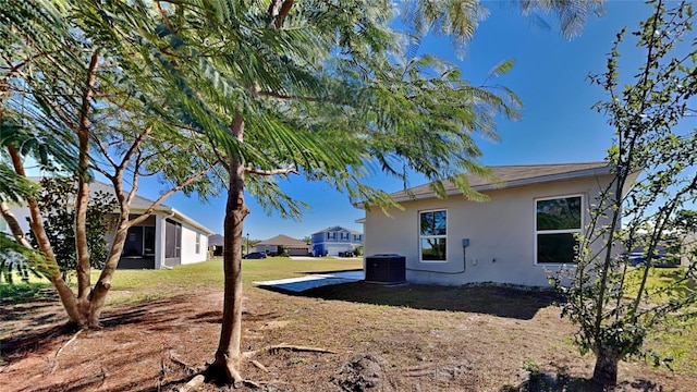 view of side of home with a yard