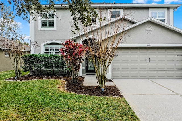 view of front property featuring a garage and a front yard