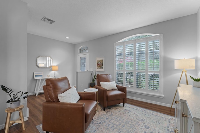 sitting room with a textured ceiling and hardwood / wood-style flooring