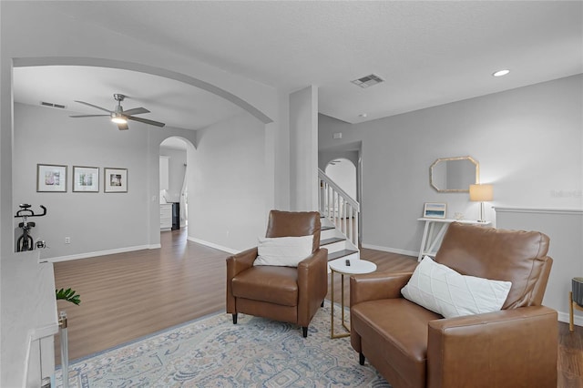 sitting room featuring wood-type flooring and ceiling fan