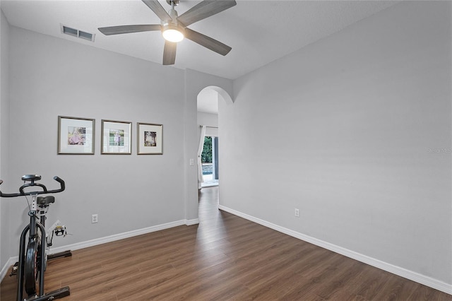 interior space with ceiling fan and dark hardwood / wood-style floors